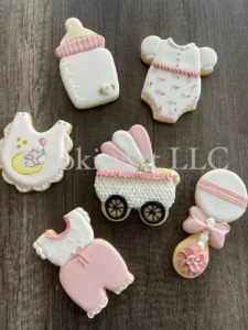 Baby-themed cookies on wooden background