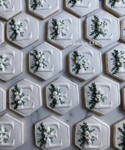 Hexagonal iced cookies with embossed "E" and flowers