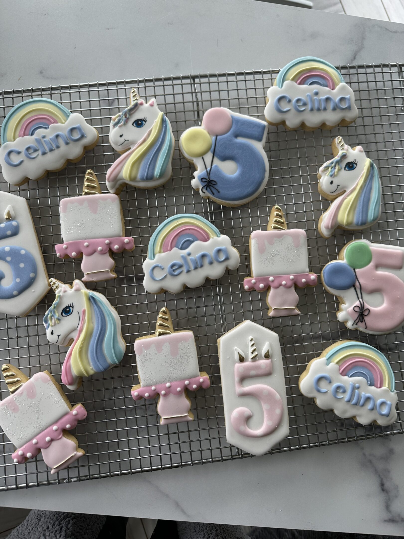 Decorated unicorn, rainbow, and number-five cookies