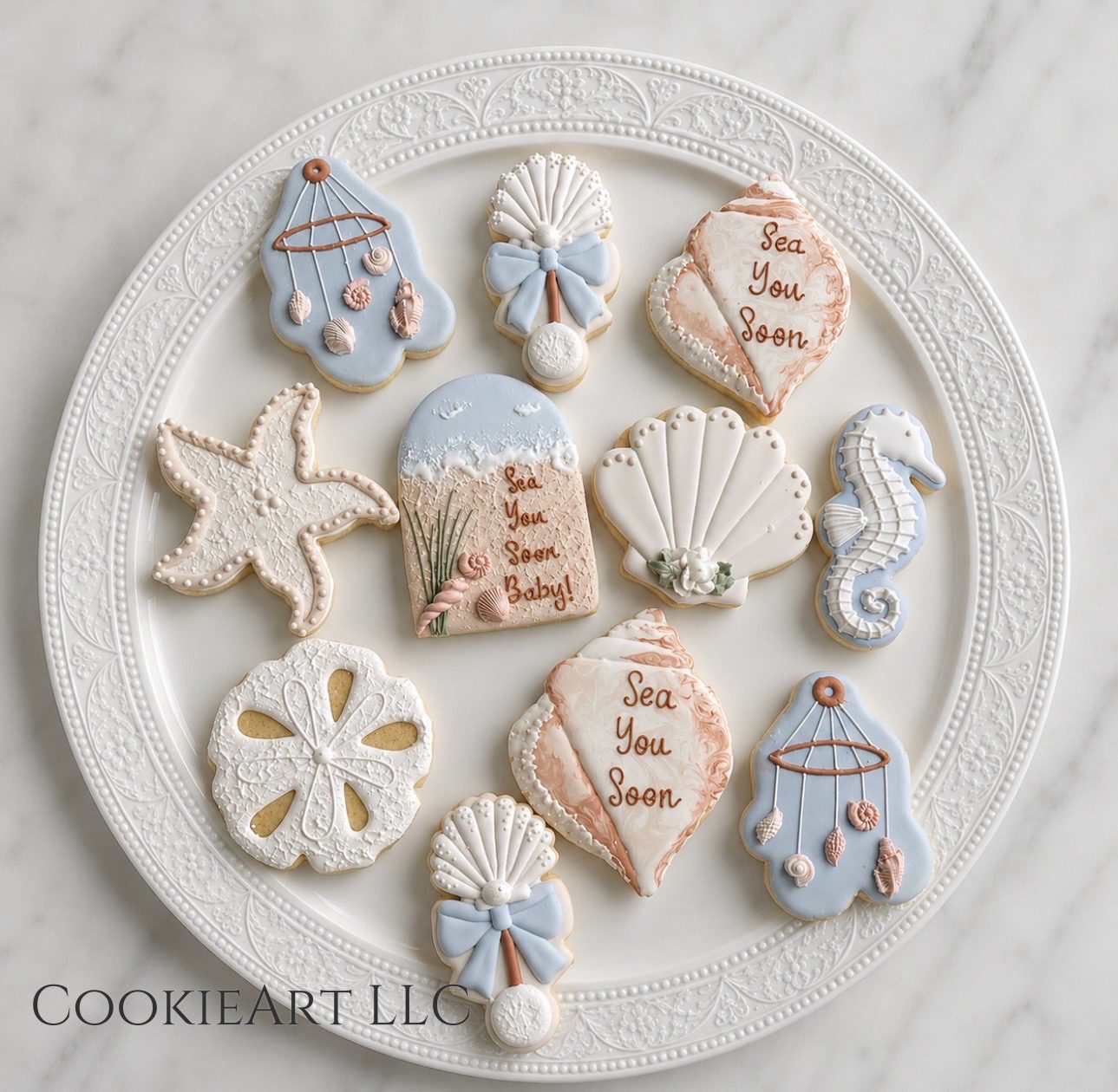 Sea-themed baby shower cookies on white plate