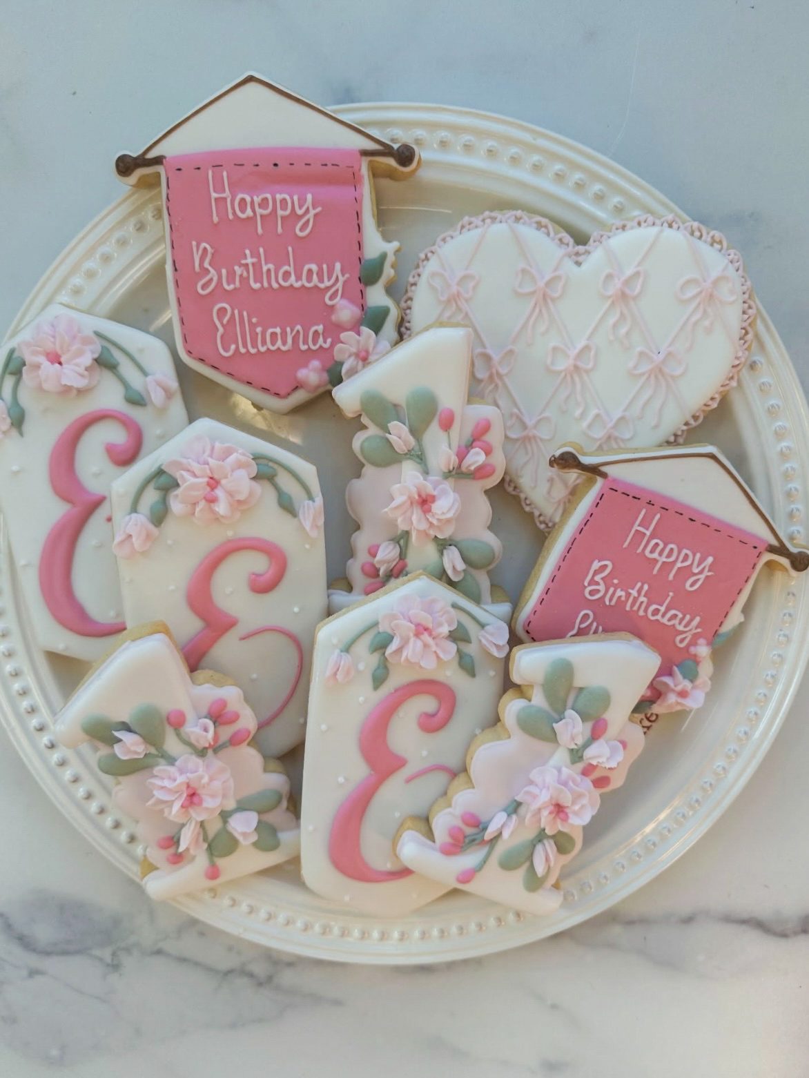 Plate of pink floral birthday sugar cookies